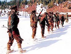 Army jawans patrolling in snow-bound mountains in deep jungles in the Rajwar area of Kupwara district, near Loc, in north Kashmir. 