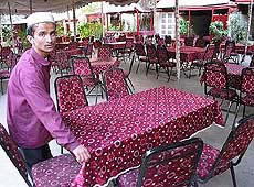 Iqbal Qasim, waiter of the Village restaurant, fixes table on Tuesday in Karachi, Pakistan, where Daniel Pearl agreed to meet Siddique, which may be an alias, a popular spot favoured by foreigners.