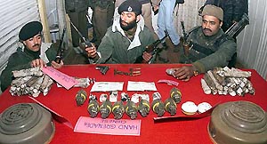 BSF men display seized arms and explosives in Srinagar