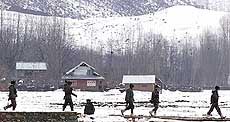 Army men patrol an area