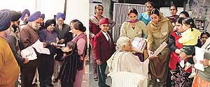 Supporters of the Akali-BJP alliance candidate from Ludhiana-west, Mr Avtar Singh Makkar, train people to press the button at serial no 2 while explaining to them the use of the voting machine. 