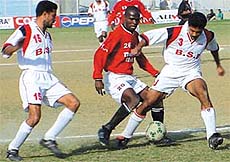 Mahindra & Mahindra and BSF Jalandhar players vie for the ball in the Durand Cup.
