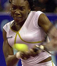 Venus Williams of the USA returns a backhand to defending champion Amelie Mauresmo of France during their semifinal of the Gaz de France Tennis Tournament at Coubertin Stadium in Paris on Saturday.