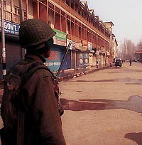 A securityman stands guard in the deserted market place