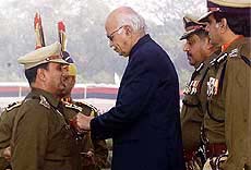 Union Home Minister L. K. Advani presents a police medal