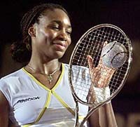 Venus Williams of the USA looks at the Diamond Racket trophy