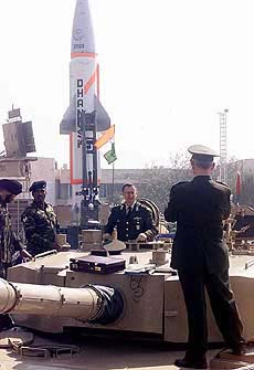 A Russian defense personnel posing in front of an Arjun tank