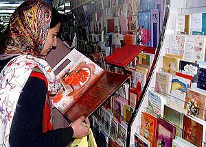 A girl looks at an Id greeting card in a  shop in Srinagar 