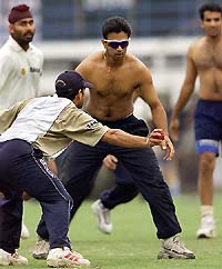 India's Sachin Tendulkar dodges teammate Rahul Dravid 