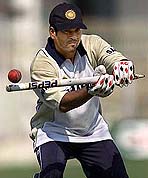 Indias star batsman Sachin Tendulkar uses a wicket to give catching practice 