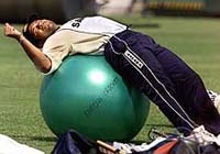 Sachin Tendulkar stretches on a medicine ball