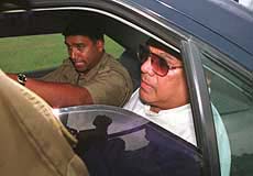 Sri Lanka's former Deputy Defence Minister Anuruddha Ratwatte (R) is escorted to Welikada prison