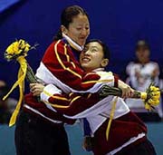 Yang Yang (A), left, is hugged by teammate Yang Yang