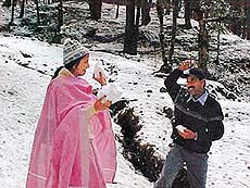 Tourists enjoy the fresh snowfall in Shimla on Monday.