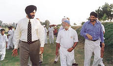 Former Indian Test opener Navjot Singh Sidhu, who came calling at the Dronacharya Cricket Foundation, being shown around by Gurcharan Singh and Maninder Singh.