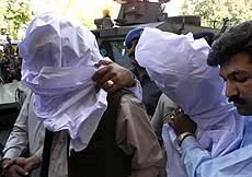 Two unidentified suspects are on their way to a court