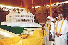 Pilgrims view a model of the proposed temple