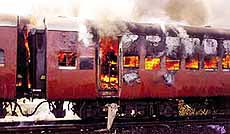 Smoke pours from the carriage of a train on fire