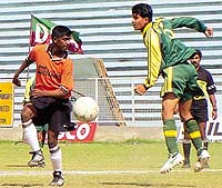 The players from Shahdara F.C. (orange) in a tussle for the ball with N.D.Heroes (green) during the DSA-SAIL Senior Division Football League Championship 