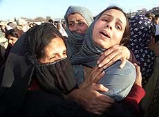 Pakistani women cry during the funeral