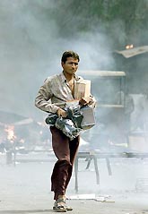 A rioter walks away with goods