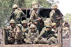 Army soldiers patrol through the streets of Ahmedabad on Friday.