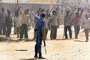 A riot policeman asks rioters to calm down in Ahmedabad on Friday.