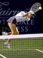 Martina Hingis, of Switzerland, returns a volley