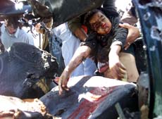 Rescue workers remove the body of a Palestinian boy