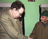 Michael Koch (left), political representative of the New Delhi Embassy of the Federal Republic of Germany shakes hand with Abdul Gani Bhat