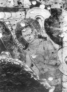 A figure of Buddha painted in the vaulted roof of a cave in Afghanistan.