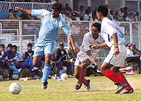 UP Police (blue) and A.S.E.B. Sports Club, Assam (white ) in action during the drawn(1-1) 2nd Division National Football League at the Ambedkar Stadium in the Capital on Saturday. 