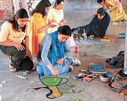 A student of the Government College of Art, Sector 10, puts her artistic skills to test in the floor-painting contest of Renaissance II on the college premises in Chandigarh on Monday.