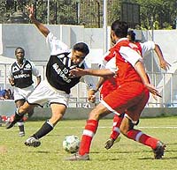 Players of Indian Nationals (in black and white jersey) and the Mughals battling it out for supremacy in the first leg semi-final of the DSA Senior Division Championship at the Ambedkar Stadium in Capital on Monday. 