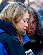 Sisters Alida (L) and Denise Silva (R) grieve the loss of their brother Santos