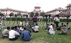 Electronic mediamen and photographers wait for conclusion of a Supreme Court hearing