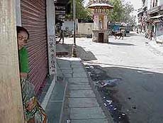 A woman peeps from her house
