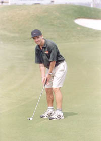 Cricketer Paul Strang of Zimbabwe tries his hand at golf in the Citibank tourney.