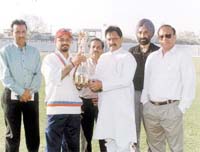 Former Indian Test opener Chetan Chauhan giving away the SAIL Trophy to TYCA captain Rajinder Madan, in the presence of another former Indian player, Surinder Khanna and Dr S S Sareen and T K Bhowmik of SAIL.