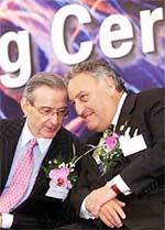 Sanford "Sandy" Weill (R), Chairman and Chief Executive Officer of Citigroup, chats with Victor Menezes, Chairman and Chief Executive Officer of Citibank
