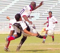 Indian Nationals (black and white ) and the Bengal Mumbai (red & white) players battling it out for supremacy in the Second Division National Football League at the Ambedkar Stadium in the Capital on Thursday.