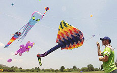 Australian Ray Wilmer flies his kite at a military barrack in the Thai resort beach town of Hua Hin