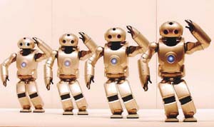 A group of SDR-4X, the latest humanoid robots by Sony Corp. , perform a synchronised dance
