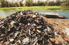 Computer waste are left along a river bank at Yaocuowei village near Guiyu.