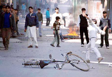A demonstrator throws stones