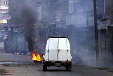 An armoured vehicle passes through the fire