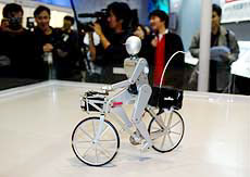 A robot rides on a bicycle