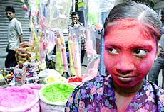 A girl is covered in gulal 