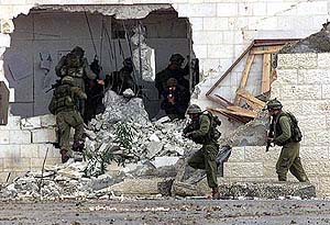 Israeli soldiers storm the headquarters of Palestinian President Yasser Arafat