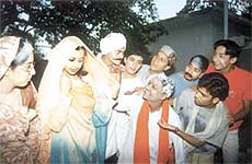 A politician teasing a lady demanding 'muawze'.